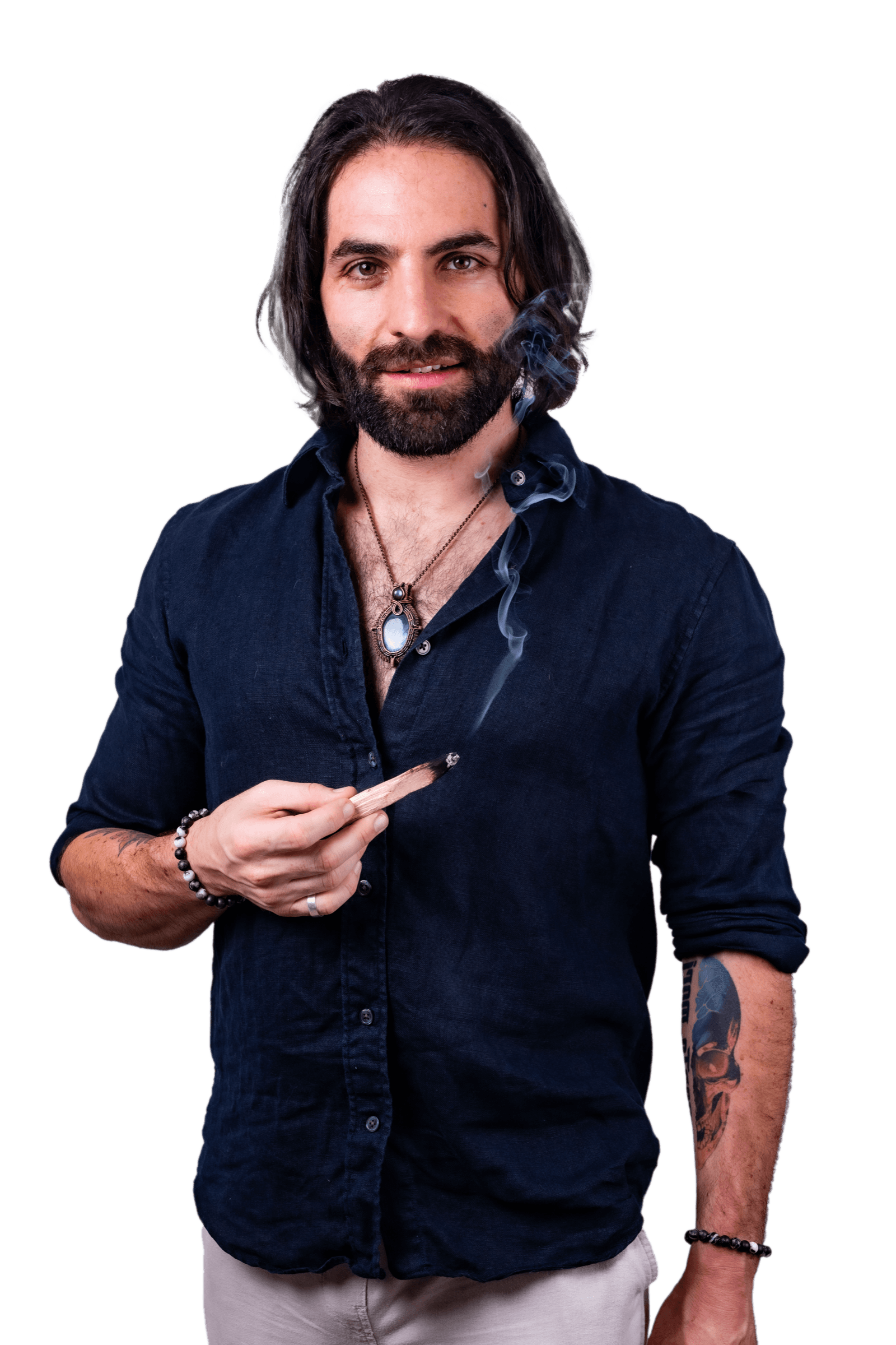 Joseph Buchoff in a navy linen shirt, holding a burning stick of palo santo as smoke rises past his face